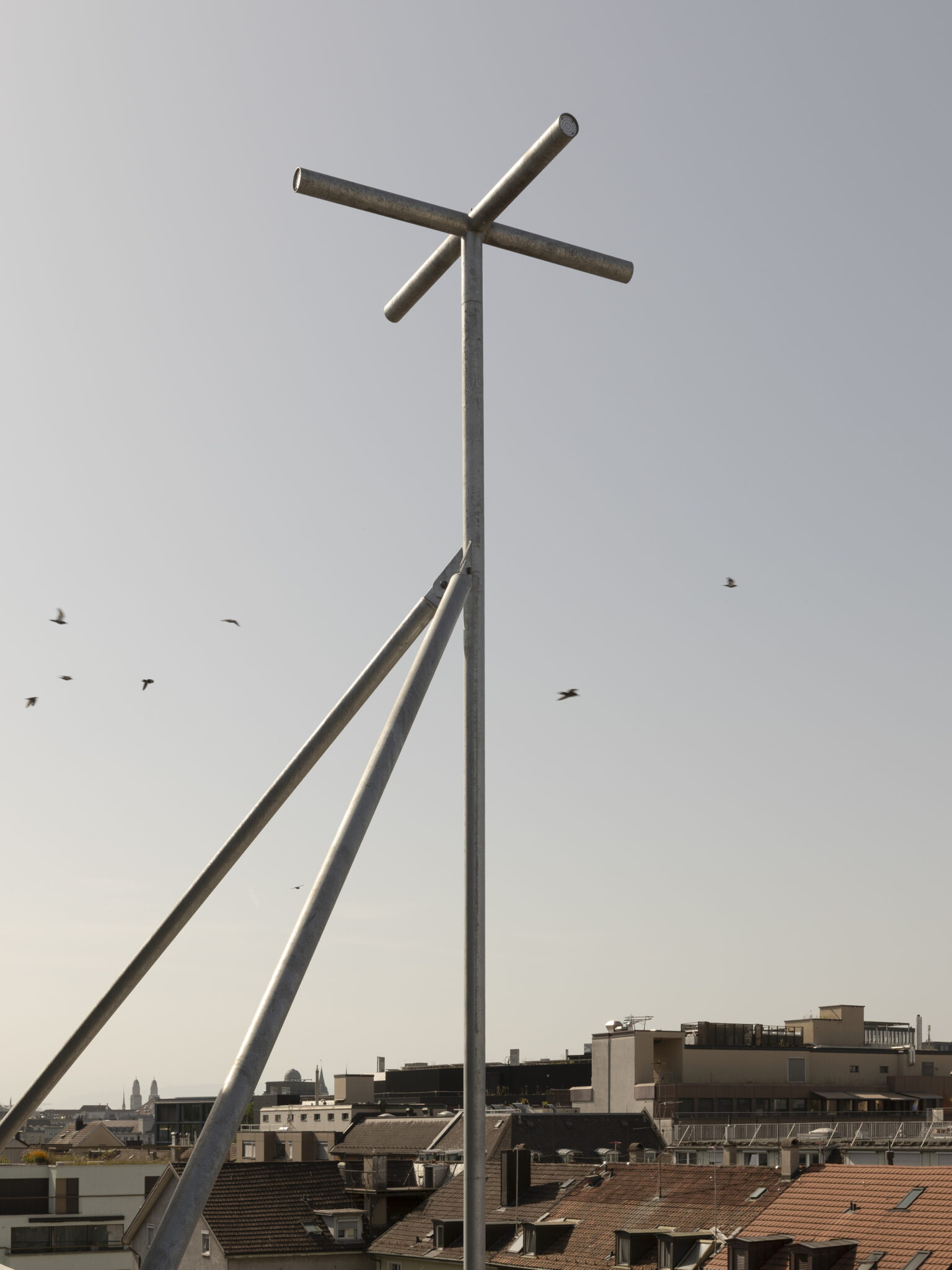 Community Echo, a 27-metre-high mast attached to the building. Four microphones are installed at each arm of the cross, recording the surrounding sonic environment. Credit: Michal Florence Schorro